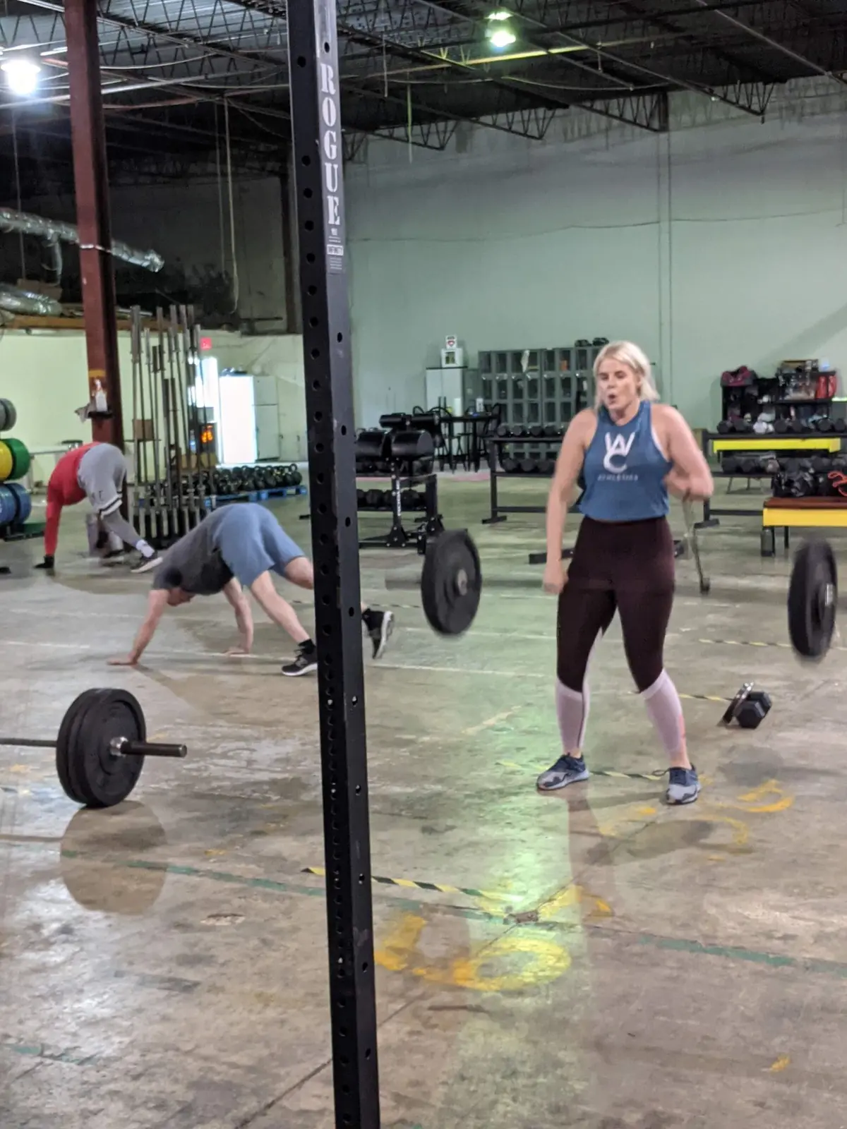 A Fit 901 member working through a barbell conditioning workout in the warehouse gym.