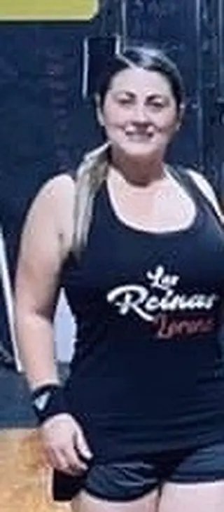 Lorena in a Las Reinas team vest on the Fit 901 gym floor, cropped from a team photograph.